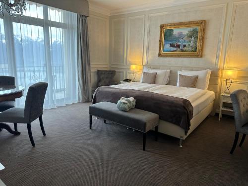a bedroom with a large bed and a table and chairs at Le Mirador Resort & Spa in Vevey