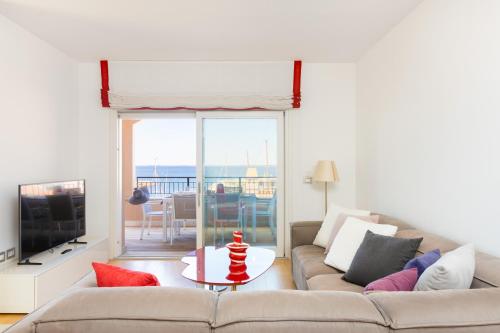 a living room with a couch and a table with a television at Portopiccolo Apartments Rubino nel Borgo in Sistiana