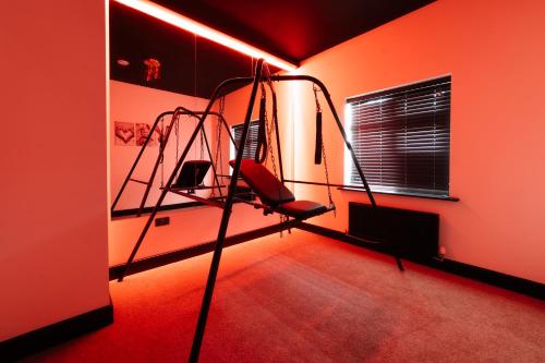 a room with two bunk beds in an orange room at Casa Amor - Adult Only Jacuzzi Suite in Southampton