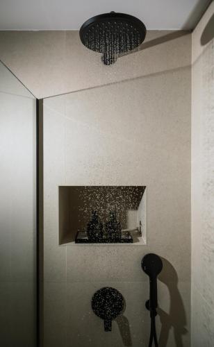a bathroom with a mirror and a sink and a lamp at Villa Repsimia with Private Jacuzzi in Kókkinos Pírgos