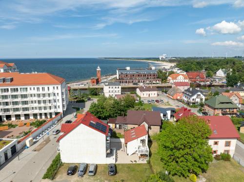 an aerial view of a town with a river and buildings at Apartamenty blisko morza Przy Wydmie in Darłówko