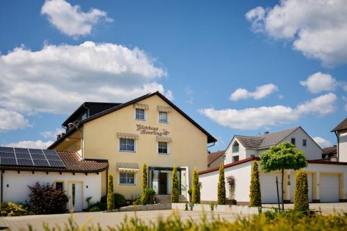 a house with solar panels in front of it at Hotel SCHNEIDER in Allersberg