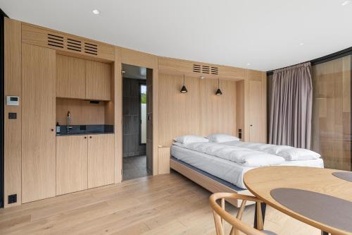a bedroom with a large bed and a table at Sogndal Fjordpanorama- The Panorama View in Kaupanger