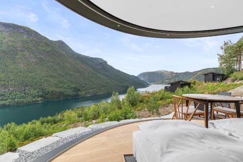 a room with a view of a river and mountains at Sogndal Fjordpanorama- The Panorama View in Kaupanger