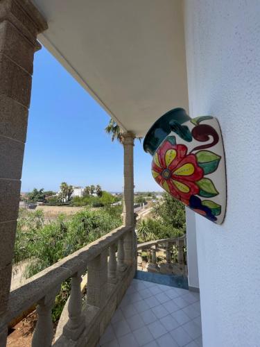 a balcony with a painting on the side of a building at Villa Salentina in Sant'Isidoro