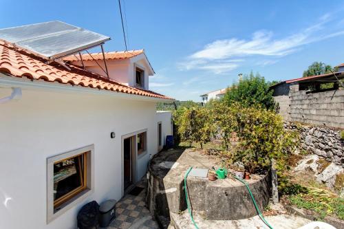 a view of a white house with a roof at Casa Do Pião - Turismo Rural in Ansião