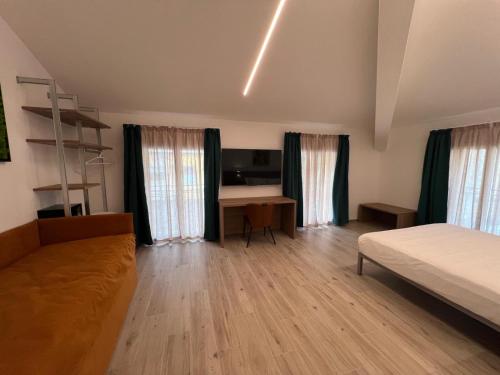 a bedroom with a bed and a desk in it at 5 Terre Hub Suite 1 in La Spezia
