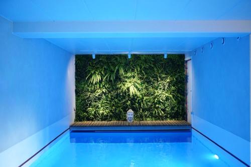 a green wall with a fire hydrant in a building at La Chamallow Vachement Douillet in Dinant