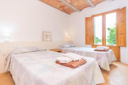 a room with two beds with towels on them at Pedra Viva -Cala Bona- in Cala Bona