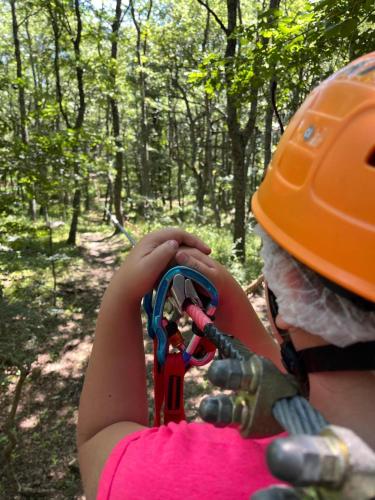 a woman in an orange helmet holding a pair of scissors at Daunia Avventura in Biccari