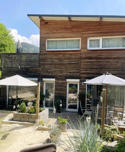 a house with two umbrellas in front of it at Chalet Maya in Schladming