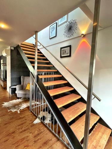a staircase in a living room with a stair case at Chalet Maya in Schladming