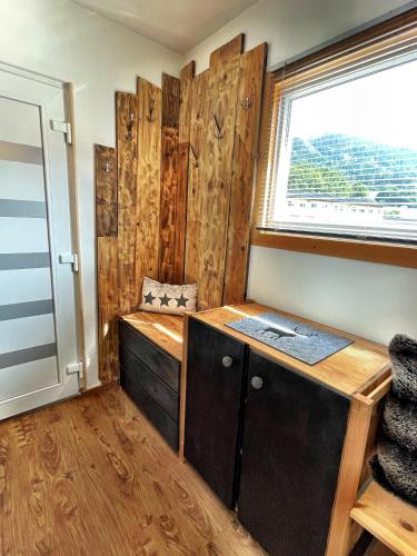 a room with a wooden desk and a window at Chalet Maya in Schladming