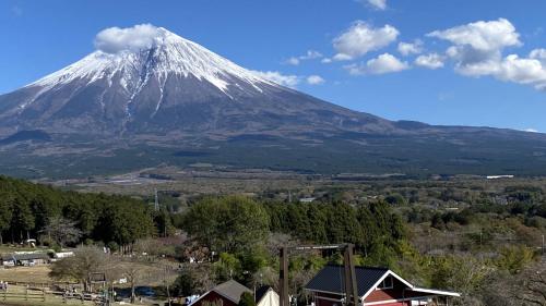 a snow capped mountain in the distance with a town at Toyoko Inn Shin-fuji-eki Minami-guchi in Fuji
