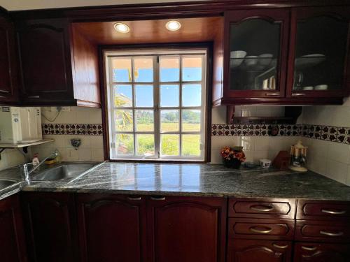 a kitchen with a sink and a window at Nestwood - By The Beach Goa in Benaulim