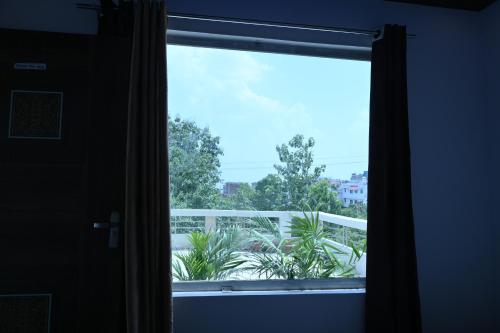 a window with a view of a balcony at Privyrooms GORAKHPUR in Gorakhpur