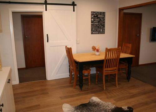 a dining room with a table and some chairs at Weka Retreat in Ashburton