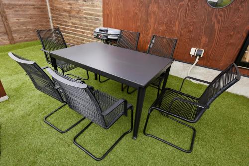 a table and chairs in a room with grass at Resoreat高島 Glamping in Imazu