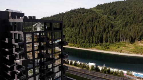 a view from the side of a building next to a river at Glacier Premium Apartments in Bukovel
