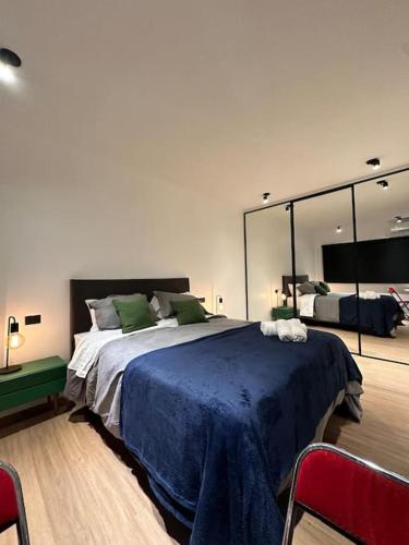 a bedroom with a large bed and a large mirror at Downtown Suite Self Check In in Buenos Aires
