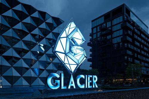a sign in front of a glass building at Glacier Premium Apartments in Bukovel