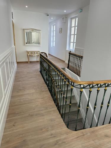 a hallway with a staircase in a house at Studio familial du Cloitre in Narbonne