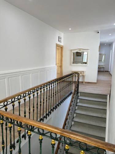 a staircase in a home with white walls at Studio familial du Cloitre in Narbonne