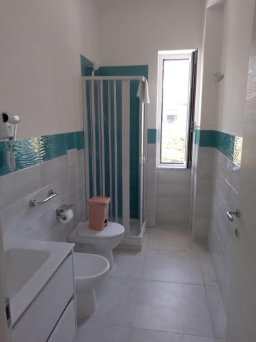 a bathroom with a toilet sink and a shower at Gianola Residence Monolocali Formia in Formia