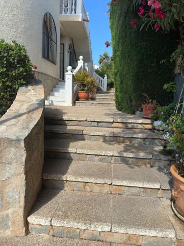 a set of stairs leading to a house at Chalet Los Almendros con piscina privada in Calpe