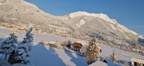 a train station in the mountains with snow on the ground at Ferienwohnung " Esserhof " Nationalpark Gesäuse in Ardning