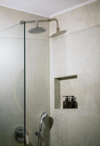 a bathroom with a shower and a sink at Villa Repsimia with Private Jacuzzi in Kókkinos Pírgos