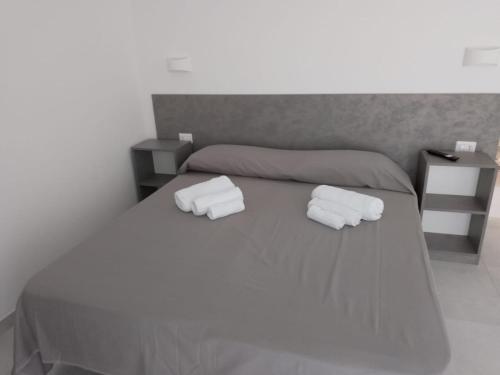a bedroom with a bed with two towels on it at Gianola Residence Monolocali Formia in Formia