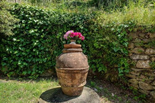 a vase with flowers sitting on top of it at Happy Childhood by the Stream in Tre Colli