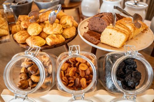 a table filled with different types of pastries and desserts at Mythos Suites Hotel in Tigaki