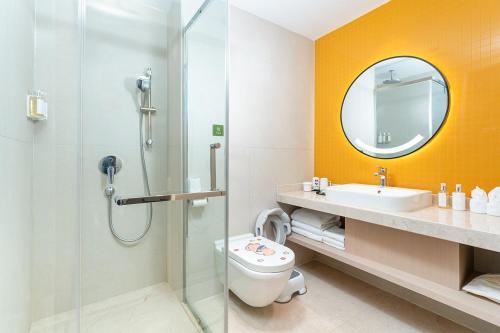 a bathroom with a shower and a toilet and a sink at Holiday Inn Dujiangyan Ancient Town by IHG in Dujiangyan
