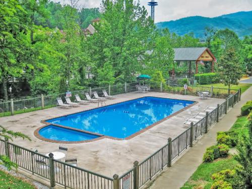 a swimming pool with chairs and a fence around it at River Terrace Resort & Convention Center in Gatlinburg