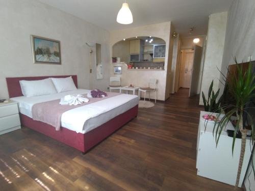 a bedroom with a large bed and a kitchen at Lea Beo in Belgrade
