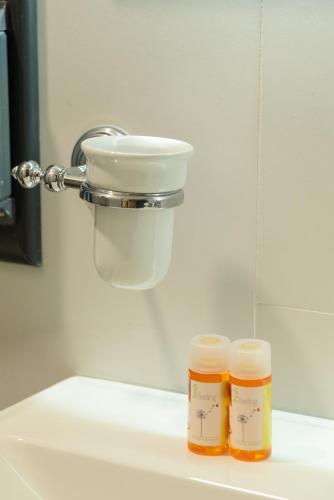 two jars of honey sitting on top of a sink at Olivium Rooms in Vlorë