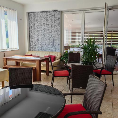 a living room with a table and chairs and a couch at Motel Maks in Kiseljak