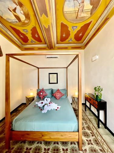 a bedroom with a bed with a painted ceiling at Corallini Luxury Apartments - Bokè Apartment in Cervo