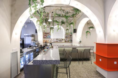 a restaurant with a bar with chairs and tables at Dogpound Hotel in Athens