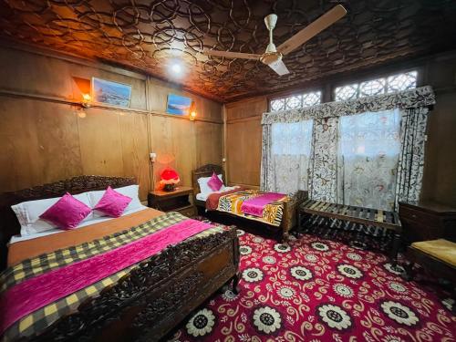 a bedroom with two beds and a window at New Sea Palace Houseboats in Srinagar