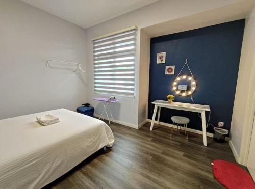 a bedroom with a bed and a table and a window at JK UpperSanctuary 8Pax 3BedR 2BathR 1Carpark in Kuching
