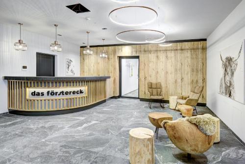 a lobby with a reception desk and chairs at Das Förstereck in Viehhofen