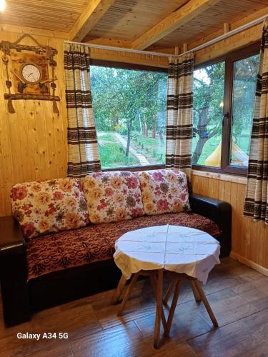 a living room with a couch and a table at La tataie Nucșoara in Nucşoara