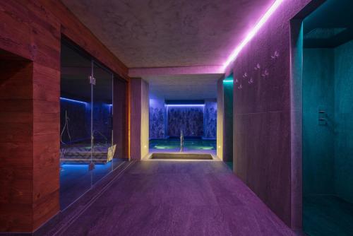 a hallway with purple lights in a house at Locanda Bellevue in Pré-Saint-Didier