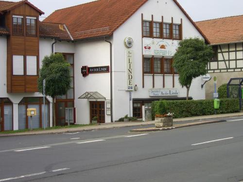 a white building on the side of a street at An der Linde in Eisenach