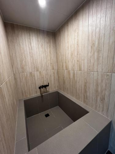 a bathroom with a bath tub with a sink at Hotel Ganwoljae in Ulsan