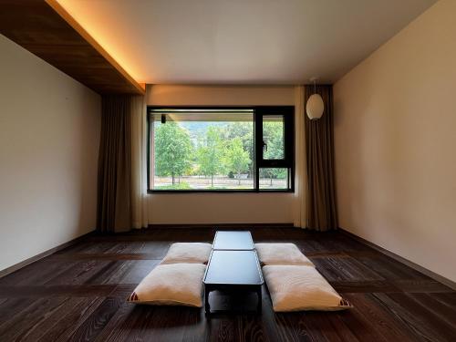 a room with a couch in front of a window at Hotel Ganwoljae in Ulsan