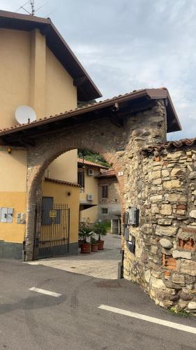 an entrance to a building with a stone wall at Casa Faét in Adro